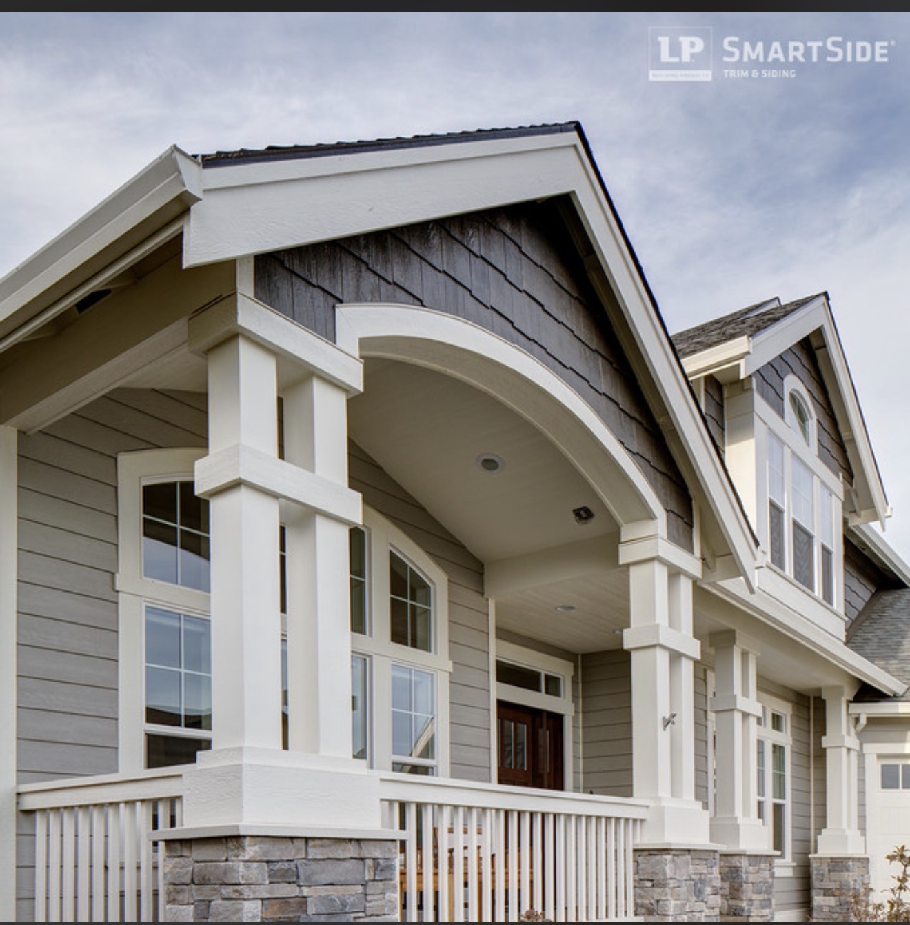 Completed gray engineered wood siding exterior with white trim
